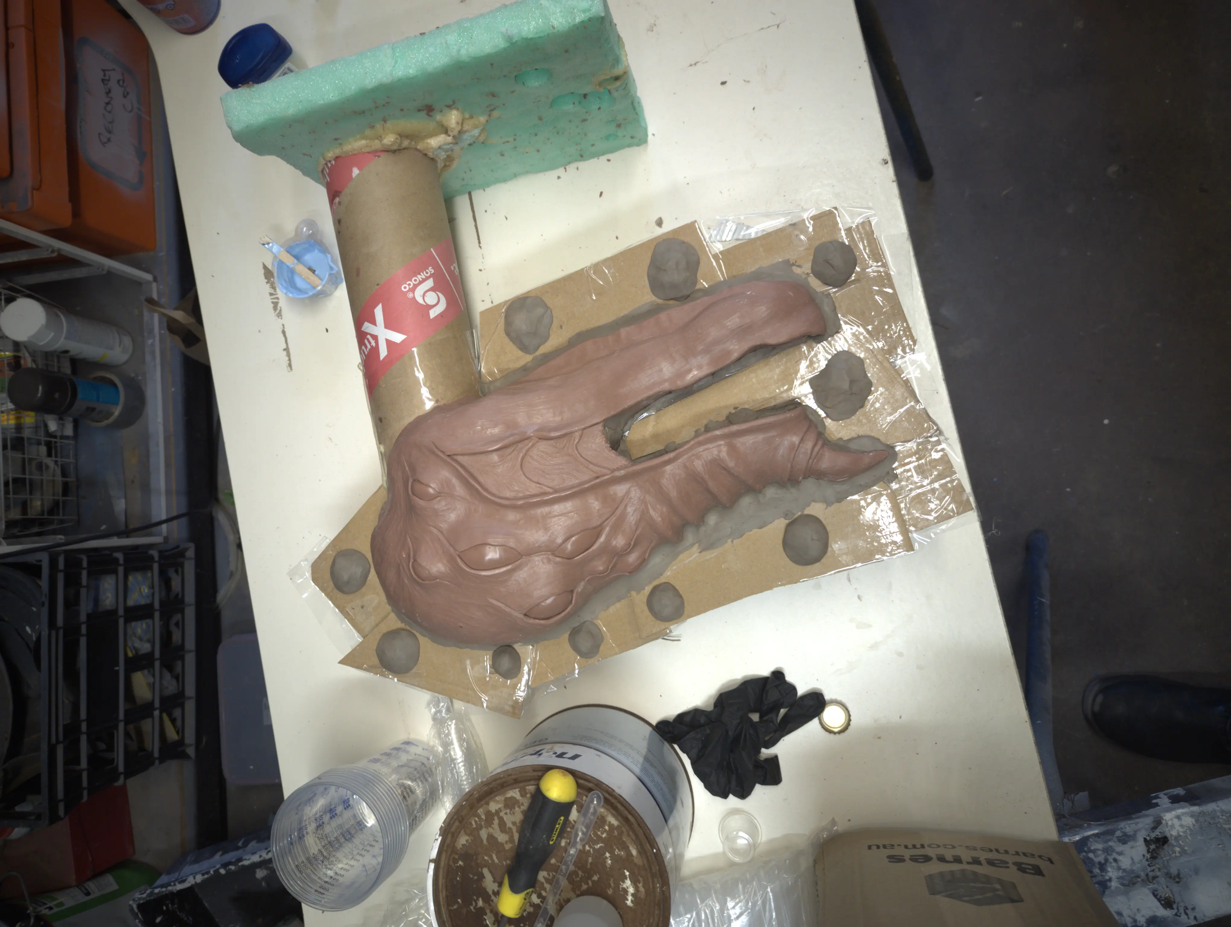 Clay sculpt prepared for mold with cardboard flange